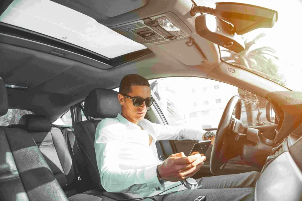 A man texting in a car