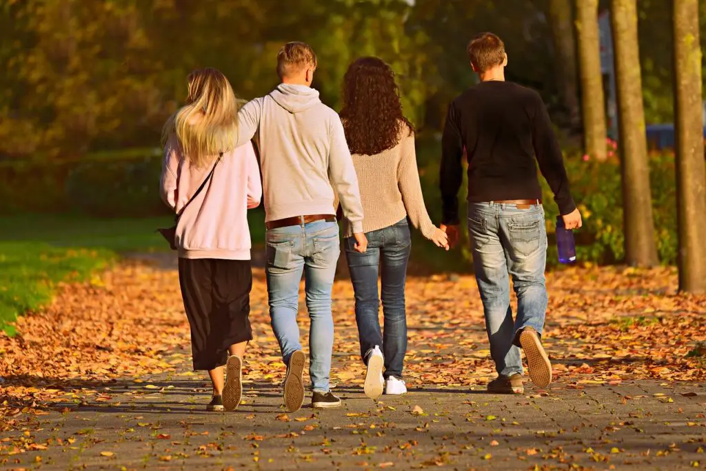 Groups of people strolling while holding hands 